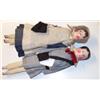 Pair of mid 19th Century wooden peg dolls having painted features, jointed wooden bodies and orig...