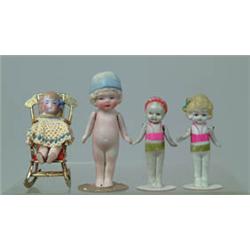 LOT OF 12 ALL-BISQUE DOLLS AND BRASS CHAIR.