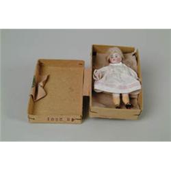 MINIATURE BISQUE ARTICULATED DOLL IN SMALL, POSSIBLY ORIGINAL BOX.