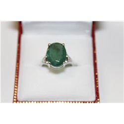 LADIES 14 KT. WHITE GOLD NATURAL EMERALD DRESS RING CLAW SET WITH 1 OVAL MIXED CUT