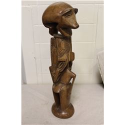 PAPAU NEW GUINEA PIG MAN CARVING 20" HIGH. DOUBLE-FACED FIGURE SURMOUNTED BY PIG, SYMBOL OF WEALTH,