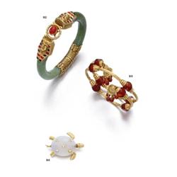 A GOLD AND CARNELIAN BANGLE...