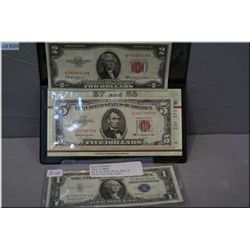 An American red seal 1953 $2 bill and red seal 1963 $5 bill and an American blue seal 1957 $1 bill