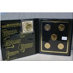 A set of cased 2003 gold plated State quarters and a gold plated Sacagawea dollar coin