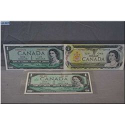 Three Canadian $1 bills including 1954, 1967 and 1973