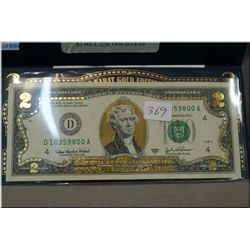 An American 22 karat gold edition two dollar bill