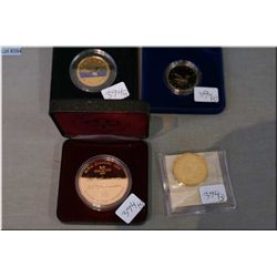 Three Canadian boxed coins including 90th anniversary, coloured loonie, 1987 loonie and loose 1987 l