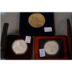 Selection of boxed Canadian coins and token including Camp Vernon token, commemorative Winnipeg doll