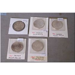 Five Canadian silver dollars including 1958, 1963, 64, 65 and 1966