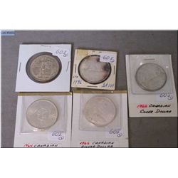 Five Canadian silver dollars including 1936, 1958, 1964, 1965 and 1966