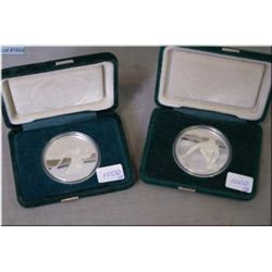 Two 1988 Calgary Olympic $20 sterling coins, one curling and one hockey