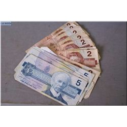 Twelve 1986 Canadian $2 bank notes and five 1986 $5 bank notes