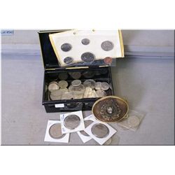 A metal coin box containing large selection 1968 Canadian coins and a Northwest Mounted Police belt 