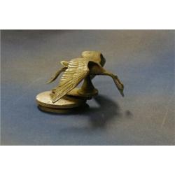 A 1920's car mascot in the form of a flying bird £20-30...