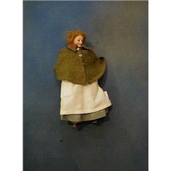 A 19th/20th Century porcelain headed doll in a nurses uniform £30-50...