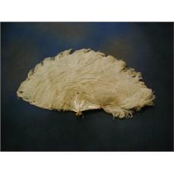 A ladies mother of pearl and white ostrich feather fan and a pair of pince nez £50-75...