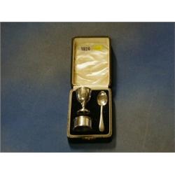 A silver egg cup, ditto napkin ring and spoon, cased £40-60...
