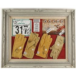 Glass framed display of PBR gloves and autographs