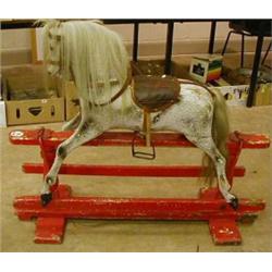 Pitch pine rocking horse on red rockers (needs some restoration) £200-300
