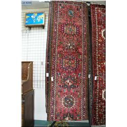 Long wool carpet runner with multiple medallions, triple border in shades of burgundy, red, and blue