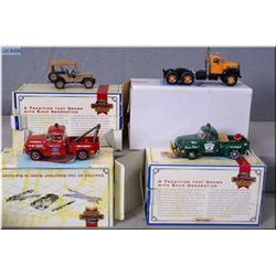 Four collectible boxed Matchbox die-cast cars including two tow trucks, a semi tractor unit and a Je