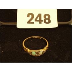 18ct gold ring with two turquoise stones set with five diamonds…