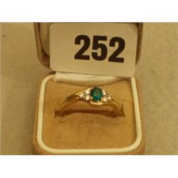 18ct gold emerald ring set with six diamonds…