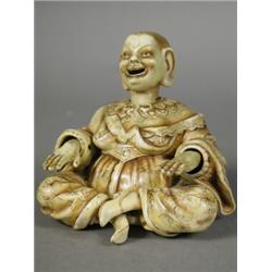 A late 19th century Ernst Bohne & Son ivory ground porcelain figure of a seated mandarin, with no...