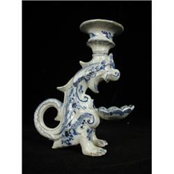 A French Faience blue and white 'Dragon candle sticks' late 19th/early 20th century (nose chipped...