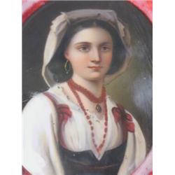 A 19th century continental porcelain oval plaque of a young woman in national costume, framed and...