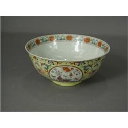 An early 19th century Quing dynasty yellow ground bowl on a circular foot, the interior with poly...