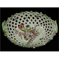 An oval bowl basket circa 1760, with a painted central flower spray, (chipped foot and restoratio...