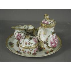 An outside decorated Meissen cabaret set, decorated with putti and gilt and floral borders, compr...