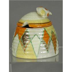 A Clarice Cliff beehive honey pot and lid, decorated in a geometric pattern, base with signature...