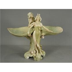 A Royal Dux Art Nouveau double bowl in the form of two liley pads supported by two maidens, pad m...