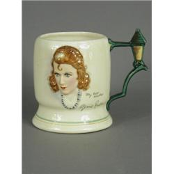 A Crown Derby Fieldings musical china mug with a relief portrait of Gracie Fields on one side, th...