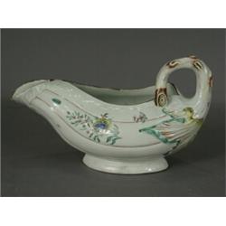 A Worcester 'Cabbage Leaf' sauceboat, painted with polychrome enamels (restored base, rim), 12cm...