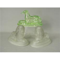Three moulded glass ornaments by J. Derbyshire, two lions and a greyhound, each with a monogram a...
