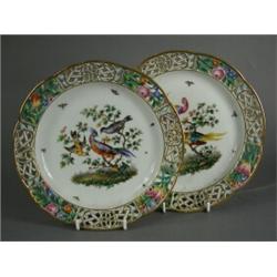 A pair of Meissen cabinet plates with enamel decoration and pierced borders, 21cm diameter (one p...