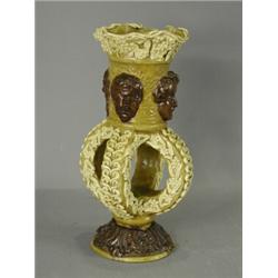 A rare Castle Hedingham vase with mask decoration and an open work centre, base impressed 'E.B.'...