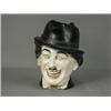 Image 1 : An early 20th century porcelain character jug inscribed 'Charlie Chaplin', with impressed numbers...
