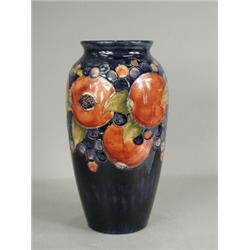 A Moorcroft vase in the pomegranate pattern, with painted incised and impressed marks, 32cm high...