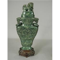 A late 19th century carved jade bottle vase, carved with relief palmettes, foliage and geometric...