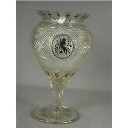 A large 19th century glass vase with a panel cut rim above a fine hob nail cut body upon a taperi...