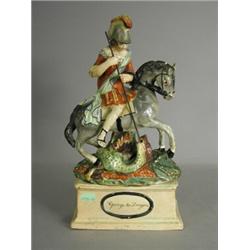 An early 19th century Wood style figure of St George killing the dragon, raised upon a rectangula...