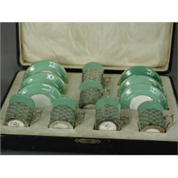 A boxed set of six Aynsley coffee cans and saucers, the cups with pierced silver sleeves, 1918 Es...