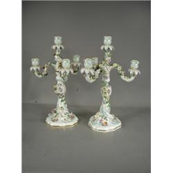 A pair of late 19th century Meissen candelabra each with three branches and applied and painted f...