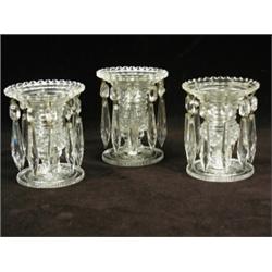 Three 19th century clear cut glass table lustres with prismatic drops, 12cm high Est. 300/400...