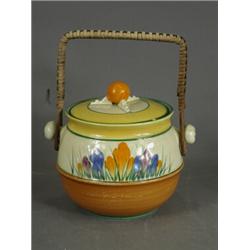 A Clarice Cliff crocus pattern biscuit barrel and lid with a wicker swing handle, base impressed...