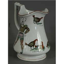 A 19th century pottery puzzle jug with two transfer printed harlequins and three cock fighting sc...